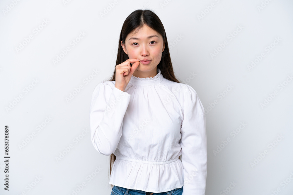 Young Chinese woman isolated on white background showing a sign of silence gesture Young Chinese woman isolated on white background showing a sign of silence gesture