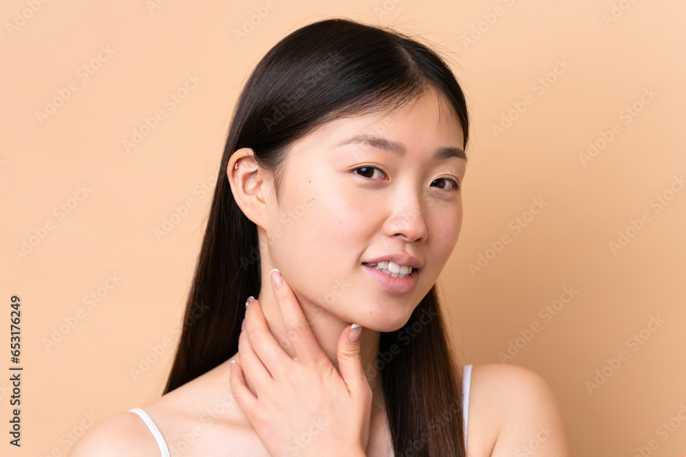 Young Chinese woman isolated on beige background . Portrait Young Chinese woman isolated on beige background . Portrait