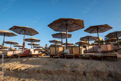beach chairs and umbrellas on the beach in the morning © Lucia