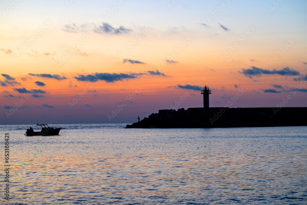Sılhouette vıew of the port and breathıng at evenıng sunset