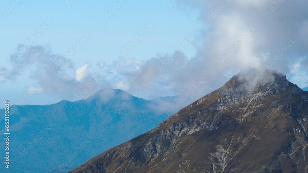 Beautiful mountain landscape. High-mountain massif, clouds over mountain peaks. Mountain slope inside a cloud, nature at a height Beautiful mountain landscape. High-mountain massif, clouds over mountain peaks. Mountain slope inside a cloud, nature at a height