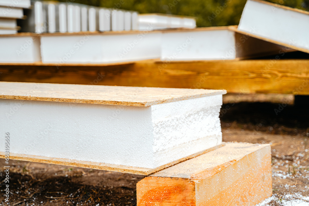 Building construction of wooden frame house made of SIP structural insulated panels. OSB oriented strand board, EPS expanded polystyrene. Energy-efficient eco-friendly green Canadian technology Building construction of wooden frame house made of SIP structural insulated panels. OSB oriented strand board, EPS expanded polystyrene. Energy-efficient eco-friendly green Canadian technology