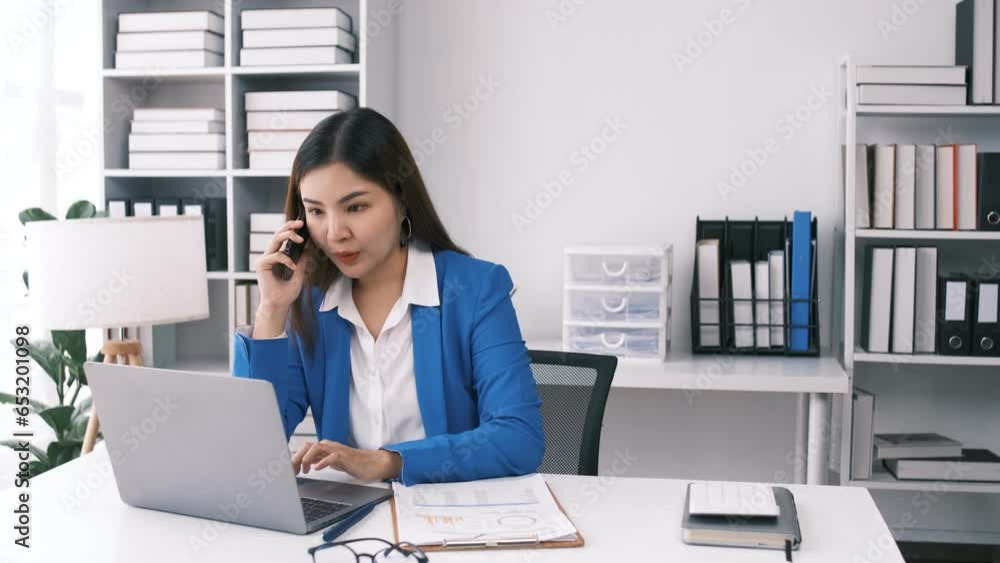 Successful confident beautiful asian woman, business leader, manager, working at the office, talking on the phone with friends or colleagues, looking away, smiling Successful confident beautiful asian woman, business leader, manager, working at the office, talking on the phone with friends or colleagues, looking away, smiling