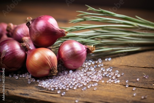 a handful of onion seeds against a rustic wooden background