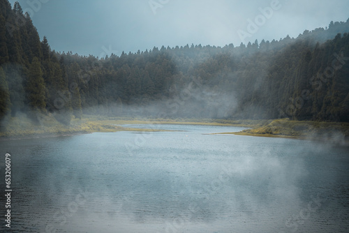 Lagoa do Eguas lake framed by a forest in a cloudy day with some low fog, Azores islands, Sao Miguel island, Portugal, Atlantic photo