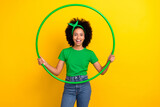 Photo of astonished lovely girl hold training hula hoop unbelievable reaction isolated on yellow color background