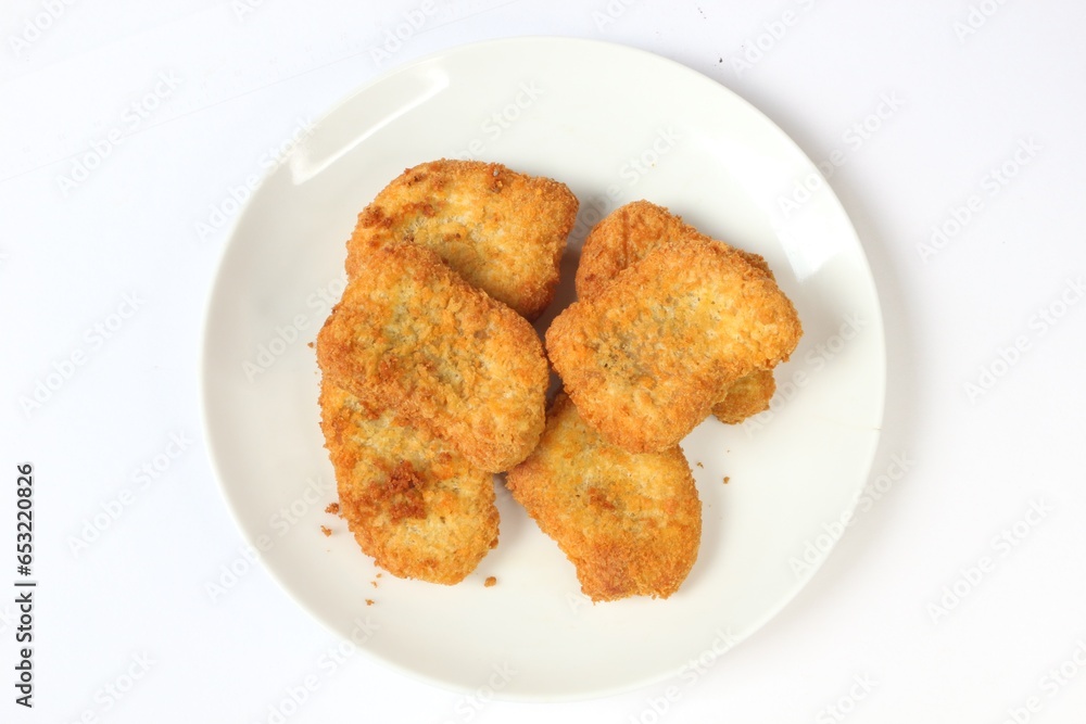 Chicken nuget is served on a plate with a white background Chicken nuget is served on a plate with a white background