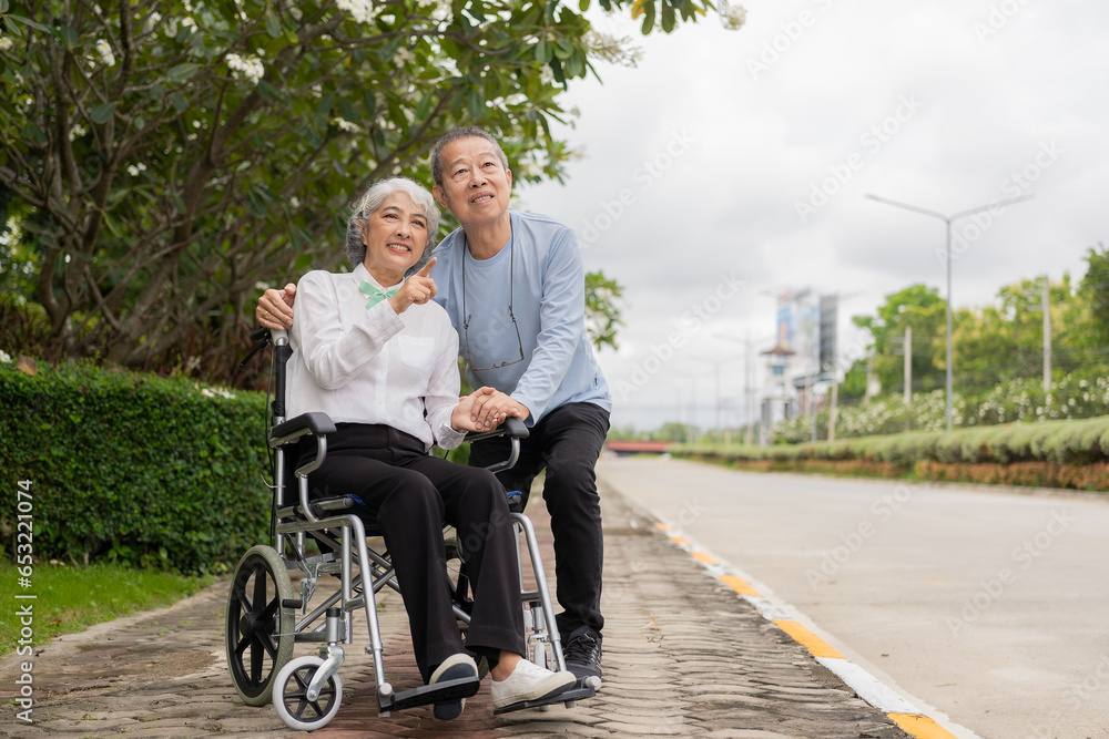 Senior Asian couple playing and teasing each other Happy family concept together outside the house Enjoy a fun lifestyle during retirement. Family health care Senior Asian couple playing and teasing each other Happy family concept together outside the house Enjoy a fun lifestyle during retirement. Family health care