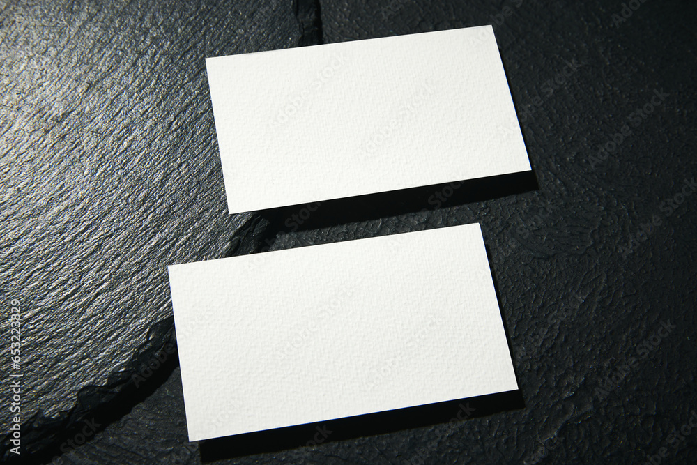 Real photo of business blank card mockup template. Design presentation layouts for corporate identity, advertising, personal, stationery over black background Real photo of business blank card mockup template. Design presentation layouts for corporate identity, advertising, personal, stationery over black background