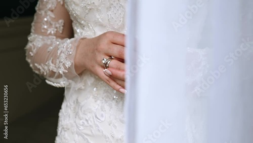 the bride twists the wedding ring on her finger while at home. medium plan. scratched hands from a cat. bride waiting to meet