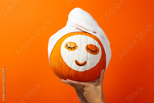 Skin and face care concept - pumpkin beauty mask