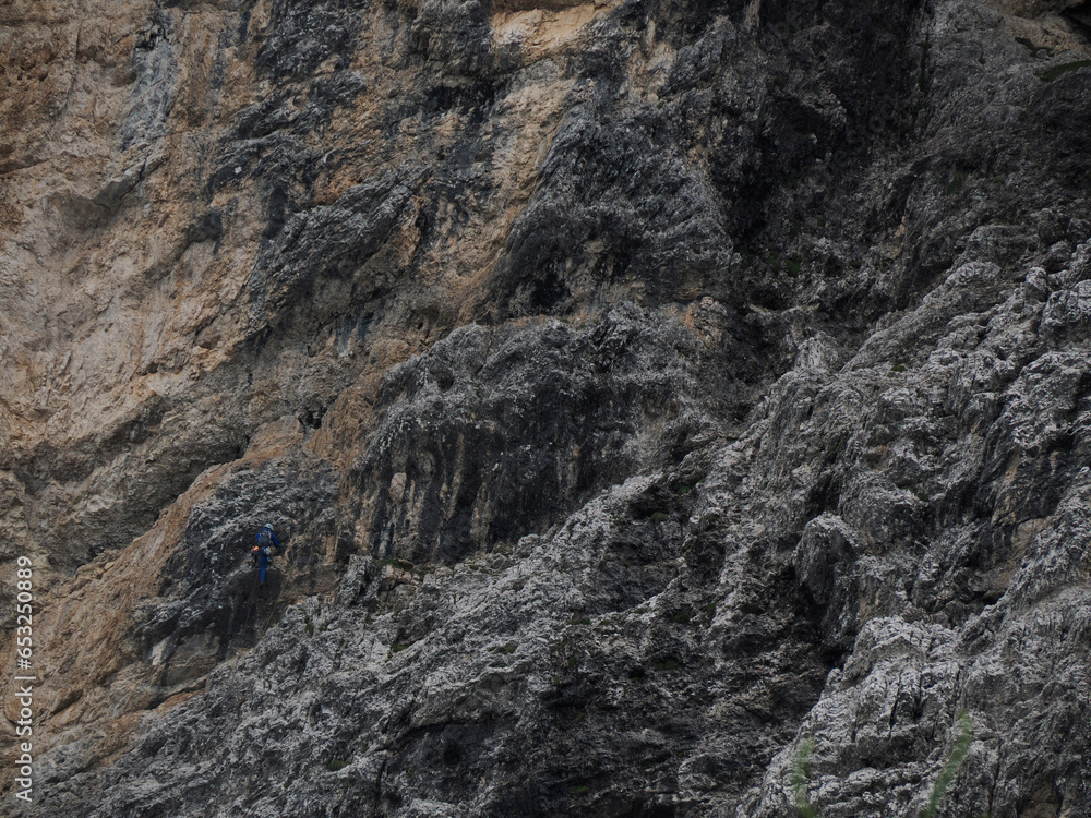 climbers climbing the rocks of monte croce cross mountain in dolomites badia valley panorama landscape climbers climbing the rocks of monte croce cross mountain in dolomites badia valley panorama landscape