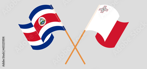 Crossed and waving flags of Costa Rica and Malta