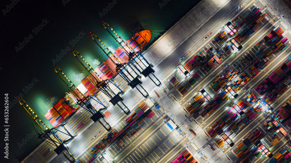 Aerial top view of Container ship loading and unloading at cargo shipping port at night, Freight Transportation, Nautical Vessel, Cargo container in deep seaport for the international order concept. Aerial top view of Container ship loading and unloading at cargo shipping port at night, Freight Transportation, Nautical Vessel, Cargo container in deep seaport for the international order concept.