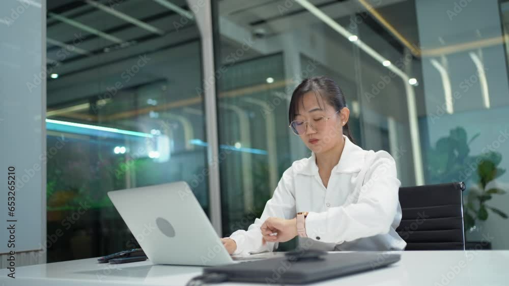 tired asian business woman using laptop computer stretch oneself after finished work and close or turn off laptop in office . exhausted worker overworked end job and take rest relaxation tired asian business woman using laptop computer stretch oneself after finished work and close or turn off laptop in office . exhausted worker overworked end job and take rest relaxation