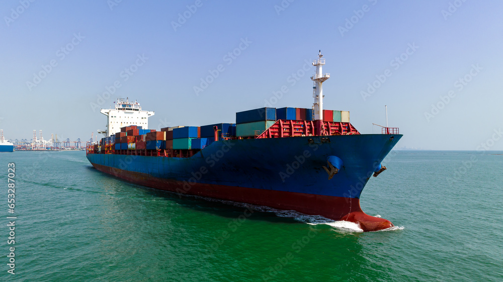Fototapeta premium cargo container ship carrying in sea import export goods and distributing products to dealer consumers across Asia pacific and worldwide global business transportation by container ship open sea