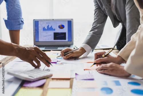 Business people discuss marketing growth chart and make business plan. Business meeting, financial consultants brainstorm analysis of statistical charts in financial reporting documents.
