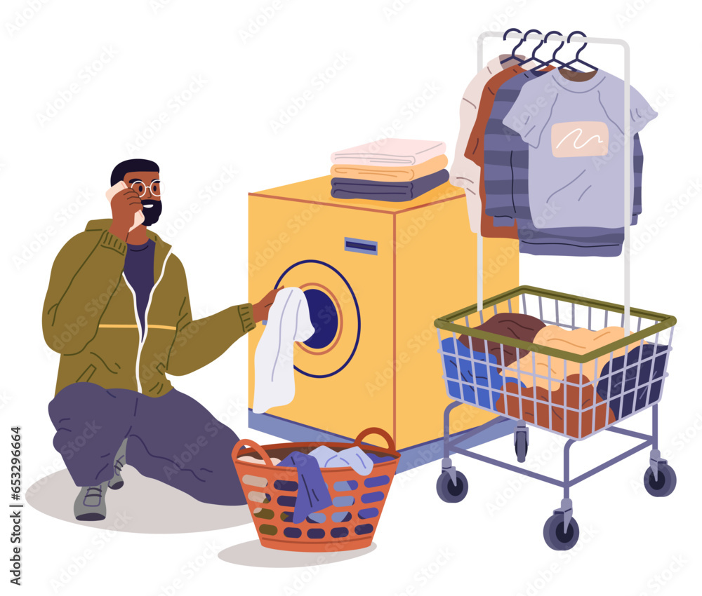 Man loading washing machine with clothes. Person putting linen into