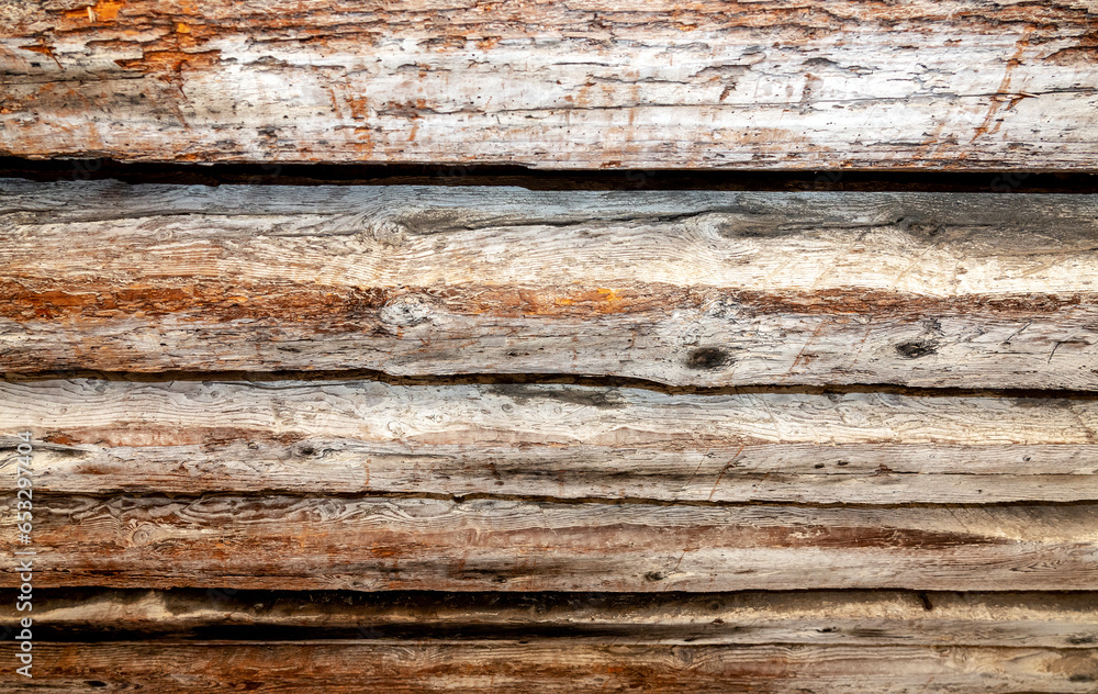 Old wooden beams holding part of buildings in Venetian pattern, rustic textured horizontal design background or wallpaper and copy space. Old wooden beams holding part of buildings in Venetian pattern, rustic textured horizontal design background or wallpaper and copy space.