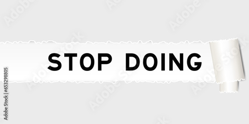 Ripped gray paper background that have word stop doing under torn part