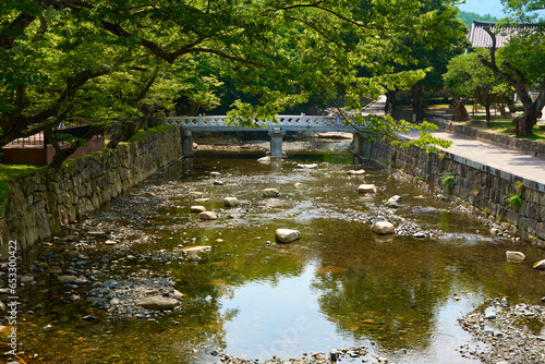 The view of a bridge and trees over a stream in front of Tongdo Temple in South Korea photo