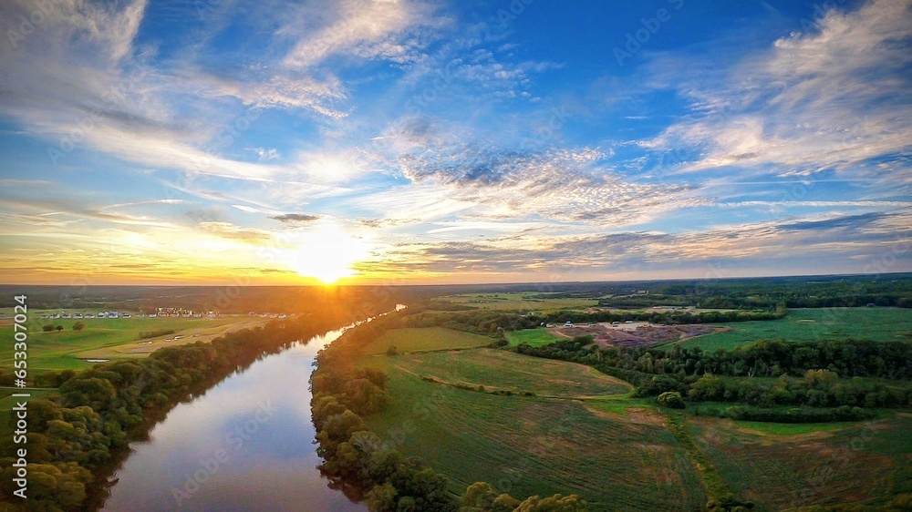 Naklejka premium sunset over a river
