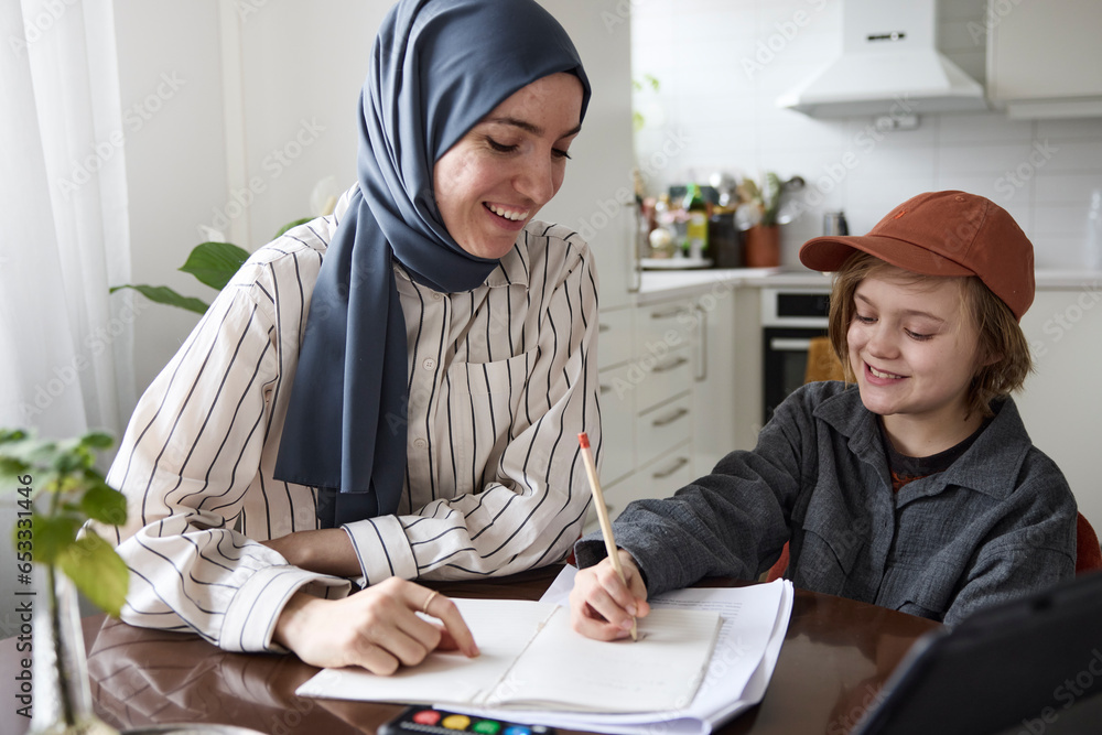 Mother helping son with homework at home Mother helping son with homework at home