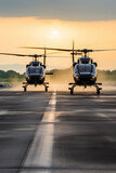 Two helicopters landing on a runway