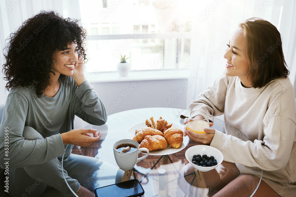Orange juice, breakfast and happy lesbian couple at table in home bonding. Drink, food and croissant of gay women in the morning together for nutrition, eating and healthy interracial relationship Orange juice, breakfast and happy lesbian couple at table in home bonding. Drink, food and croissant of gay women in the morning together for nutrition, eating and healthy interracial relationship
