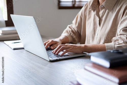 Businesswoman working on laptop.