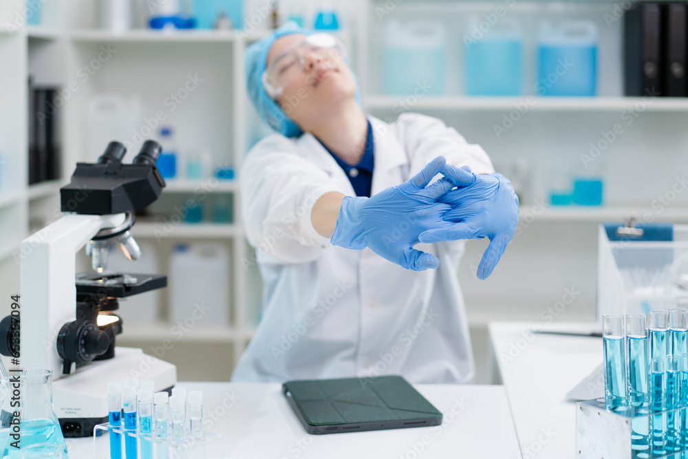 hand of scientist stretching rest from tired working overtime in laboratory, asian female doctor work overload exhausted headache while research experiment chemical liquid substance science concept hand of scientist stretching rest from tired working overtime in laboratory, asian female doctor work overload exhausted headache while research experiment chemical liquid substance science concept