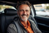 Smiling handsome man driving a car, road trip. Seat belt, safety driving concept