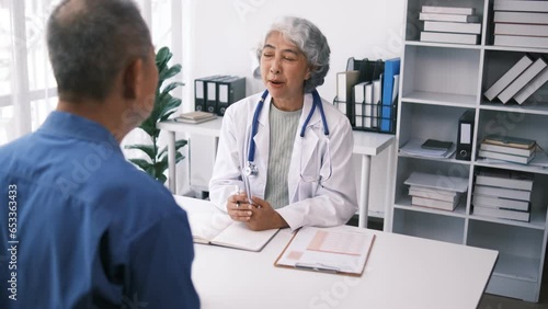 Smiling elderly female doctor wearing and uniform with stethoscope checking mature man at meeting, elderly patient making health insurance deal, older generation healthcare concept photo