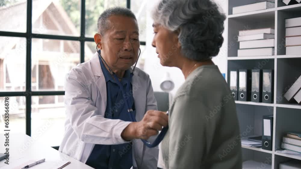 Senior male doctor with female patient hospital. Doctor and patient discussing something while sitting in hospital room. Medicine and healthcare concept Senior male doctor with female patient hospital. Doctor and patient discussing something while sitting in hospital room. Medicine and healthcare concept