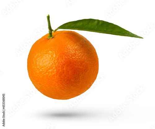 Whole tangerine with leaf on a white isolated background. A tangerine with a leaf hangs or falls casting a shadow close-up.