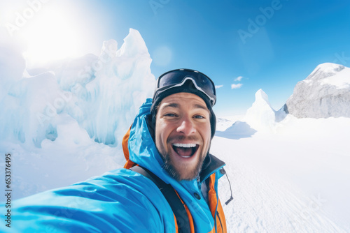 Happy smiling hiker, influencer taking a selfie photo with go pro camera on a snowy mountain