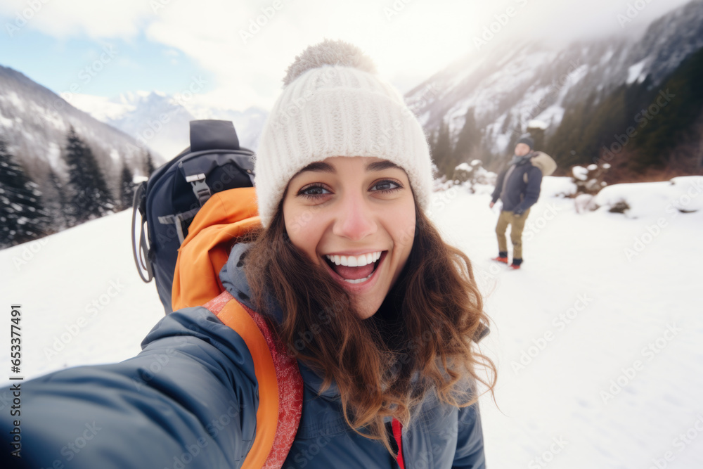 Happy woman hiker taking a selfie photo on a snowy mountain Happy woman hiker taking a selfie photo on a snowy mountain