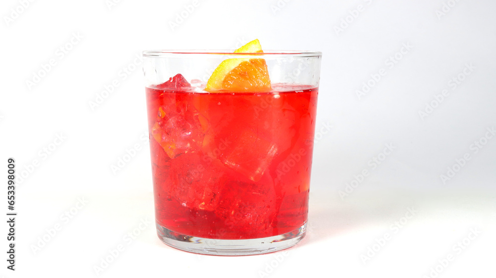 closeup of a red cocktail with ice cubes,  orange slice on a white background