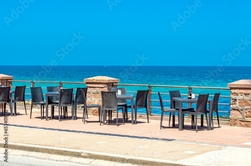 view at empty chairs of cafe during pandemic in Porto Torres Sardinia