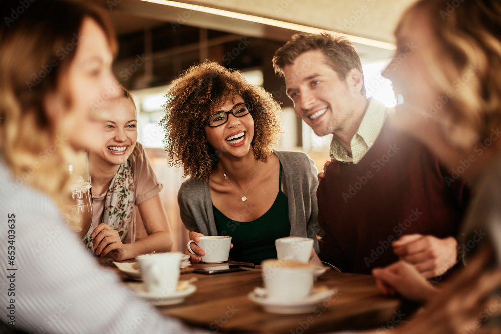 Group of young and diverse friends having coffee together in a cafe or bar Group of young and diverse friends having coffee together in a cafe or bar