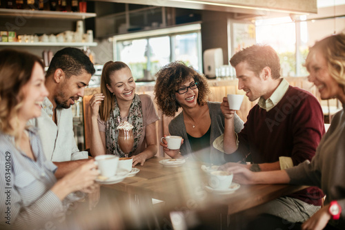Group of young and diverse friends having coffee together in a cafe or bar