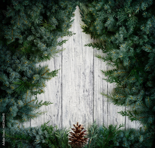 Christmas Concept - Tree  Minimal Shape - Fir Branches On Wooden Snowy Background  photo