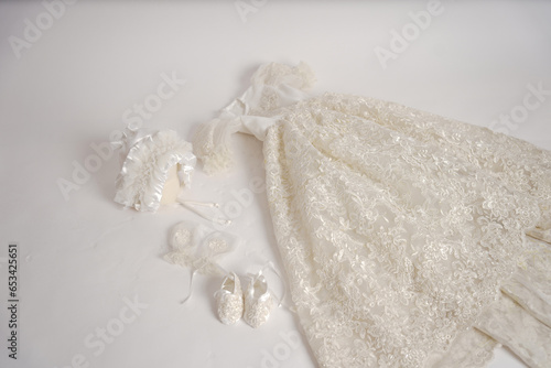 Baby vintage victorian outfit. new baby born white dresss with shoes and head wear on a white background. 