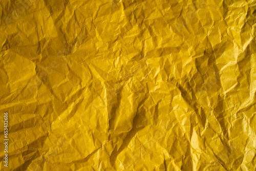 Yellow crinkled wrapping paper with a lot of texture. Concept backgrounds and templates.
