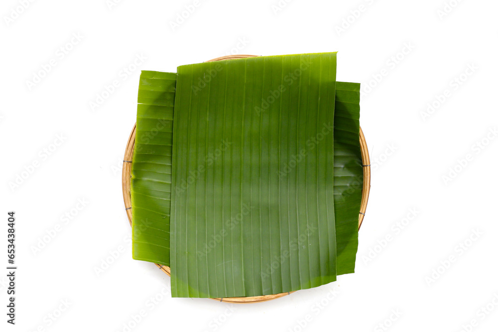 Banana leaves in bamboo weave plate on white background. Banana leaves in bamboo weave plate on white background.