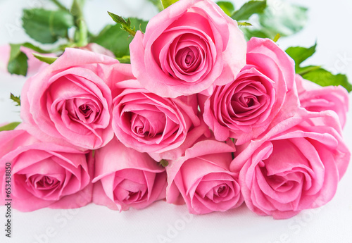 Wedding or birthday greeting card  Bunch of pink rose flowers on the white background  close up  selective focus