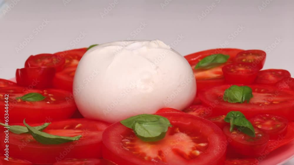 tomato, rotation in circle. Burrata, slices of tomato, green basil