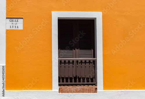Calle de la luna street Puerto rico wooden front door house background with orange paint on wall from san juan. 