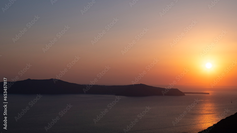 Orange sunset landscape in a cliff rock Mediterranean Sea landscape in Santorini
