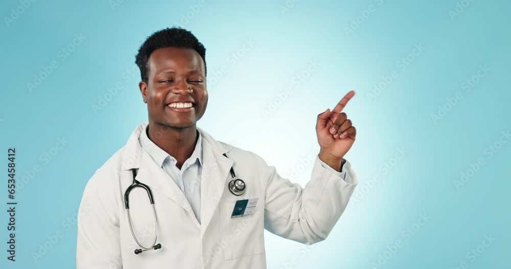 Face, pointing or doctor with space, black man or healthcare on a blue studio background. Portrait, African person or medical professional with advertising, decision or opportunity with information Face, pointing or doctor with space, black man or healthcare on a blue studio background. Portrait, African person or medical professional with advertising, decision or opportunity with information